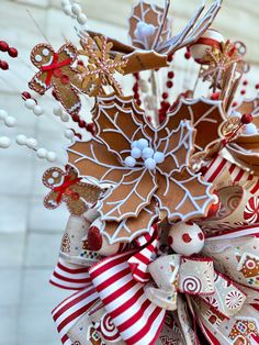 a close up of a christmas decoration with candy canes and decorations on the top