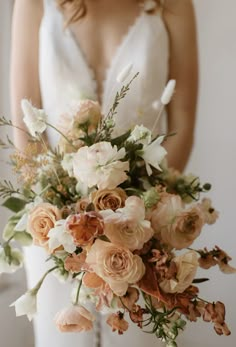 a bride holding a bouquet of flowers in her hands