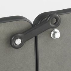 a close up view of the handles on a door with grey fabric and metal hardware