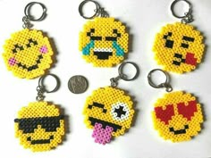 four pixel key chains with different emoticions on them