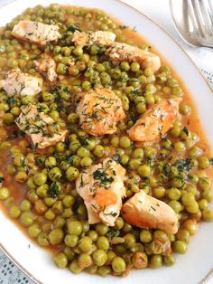 a white plate topped with peas and chicken