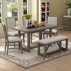 a dining room table with chairs and a bench