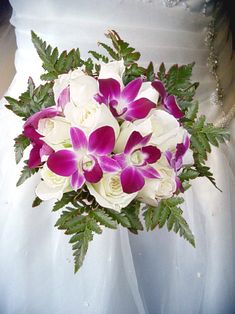 a bridal bouquet with purple and white flowers