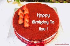 a red cake with strawberries on top and happy birthday to you written on it