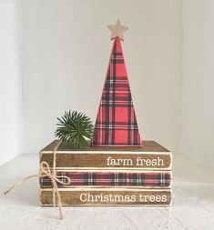 a stack of books with a christmas tree on top and the words farm fresh, christmas trees