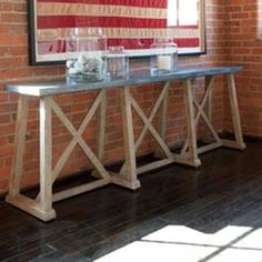 an american flag is hanging on the wall behind a console table with two vases