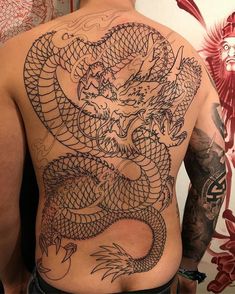 a man with a dragon tattoo on his back