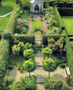 an aerial view of a garden with many trees and bushes