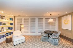 a living room filled with furniture and bookshelves