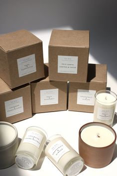 several candles and boxes sitting on a table