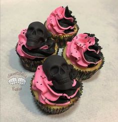 three cupcakes with pink frosting and black icing decorated with skull heads