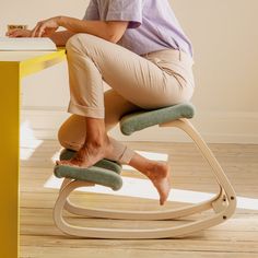 a woman sitting on a rocking chair with her feet up