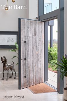 an open door leading into a room with a horse statue on the floor and plants