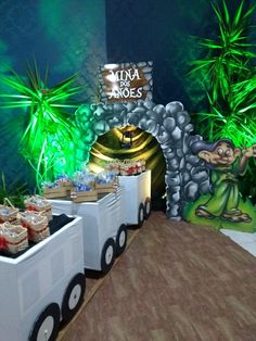 a table filled with food on top of a hard wood floor next to a stone arch