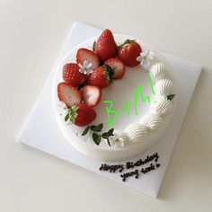 a birthday cake decorated with strawberries and white icing on a card that says happy birthday