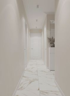 an empty hallway with white walls and marble flooring