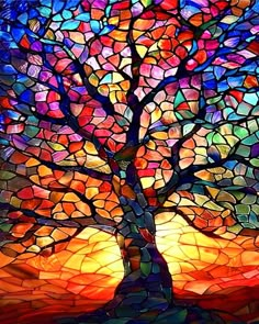 a stained glass tree with the sun shining through it's branches and colorful colors