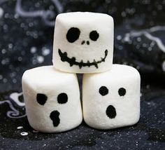 marshmallows with faces painted on them are stacked in the shape of jack - o'- lanterns