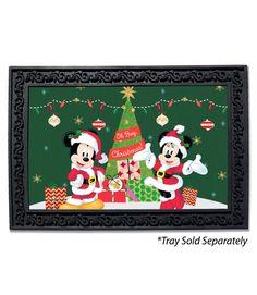 mickey and minnie mouse with christmas tree in front of green background, framed by black frame