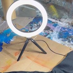 a white ring light sitting on top of a wooden table