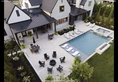 an aerial view of a house with a swimming pool and patio furniture in the foreground