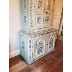 an old blue and white cabinet in a room