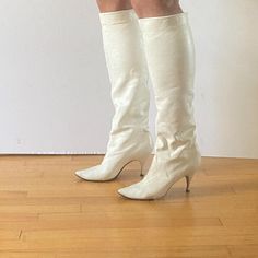 Beautiful and rare vintage 1960s Joseph white leather tall boots with little kitten stiletto heels and pointed toes. Like a very sophisticated gogo boot. The leather is so soft that it's almost stretchy, maybe kid skin (?) and these can be worn pulled to the knee or slouched down. Leather soles. Boots have some general markings and discoloration to the white leather as shown and scuffing mostly at the backs and heels. Approx 9.75" along insole from toe to heel, 2 7/8" across ball of foot, 3.25" heel height. Cream Pointed Toe Fitted Boots, Fitted Cream Boots With Pointed Toe, Fitted Cream Pointed Toe Boots, Cream Colored Fitted Heeled Boots With Pointed Toe, Fitted Cream Knee-high Heeled Boots, Fitted Cream Heeled Boots For Party, Cream Fitted Boots For Party, Fitted Cream Boots For Party, Classic Fitted Knee-high Boots For Party