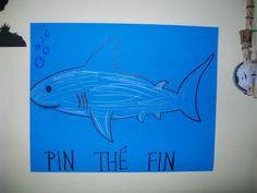 a drawing of a shark with the words pin the fin on it