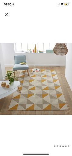 an image of a living room with furniture and rugs