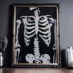 a skeleton is displayed in front of a black and white painting