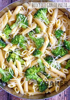 a bowl filled with pasta and broccoli covered in parmesan cheese