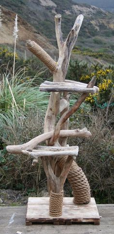 a sculpture made out of wood and rope