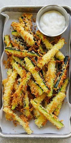 fried zucchini sticks with ranch dressing on a tray