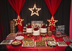 a red table topped with cakes and desserts