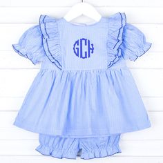 Add a sweet pop of color this fall with our adorable Light Blue Gingham Alice Bloomer Set! The charming light blue gingham top features a playful waterfall ruffle with navy picot trim details. Paired with matching light blue gingham bloomers, this set is the perfect choice for a fun and stylish day out. Plus, you can add a personalized monogram to make it uniquely yours! Cute Fitted Gingham Sets, Preppy Cotton Sets For Spring, Preppy Cotton Spring Sets, Spring Preppy Cotton Sets, Fitted Gingham Sets For Spring, Cute Plaid Sets For Spring, Cute Plaid Spring Sets, Spring Gingham Sets With Ruffles, Navy Cotton Sets For Spring