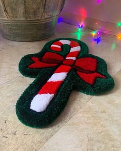 a green and red candy cane rug on the floor