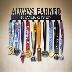 there is a sign that says always earnd never given with medals hanging from it