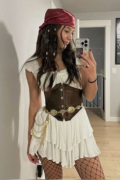 a woman in a pirate costume taking a selfie