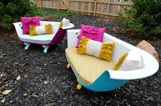 two couches and a bathtub in the middle of a yard with gravel on the ground