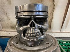 a metal skull head sitting on top of a machine