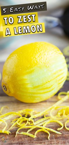 a lemon sitting on top of a wooden cutting board