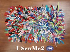 a pile of colorful clothes pins sitting on top of a wooden table with the words sew me2