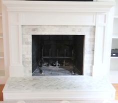 an empty fireplace with no mantle in the middle