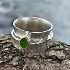 The sea glass for this ring was found on the Big Island of Hawaii. This wide band spinner ring is made from 925 sterling silver. It has been hammered to give it texture. The edges of the band have been flared to give the band a concave curve. Each side is curved so that the ring on the band cannot come off. The spinning band is made from round wire and topped with a fine silver bezel. This ring is handmade. Size 9 Photos are taken outside in sunlight and shaded areas to show the way the light shines differently on the sea glass. Beach Glass Ring, Sea Glass Ring Gold, Lime Green Sterling Silver Round Rings, Sea Glass Silver Ring, Handmade Adjustable Sea Glass Rings, Big Island Of Hawaii, Island Of Hawaii, The Big Island, Spinner Ring