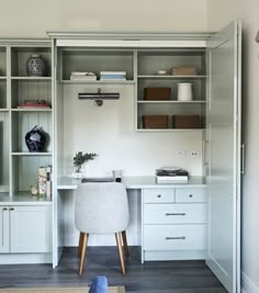 a white desk and some shelves in a room