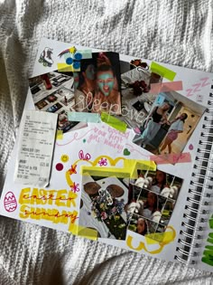 an open notebook with pictures and stickers on top of it, sitting on a bed