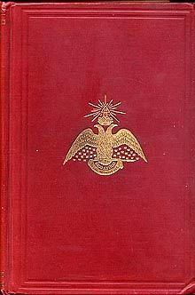 an old red book with gold trimmings and a bird on the front cover