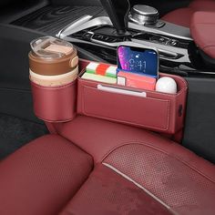 a cell phone and cup holder in the back seat of a car