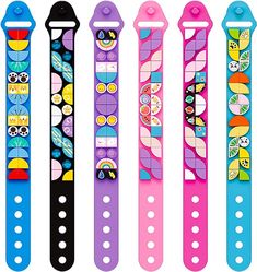 four colorful watch bands are lined up in a row, each with different designs on them