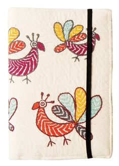 a small notebook with colorful birds on it